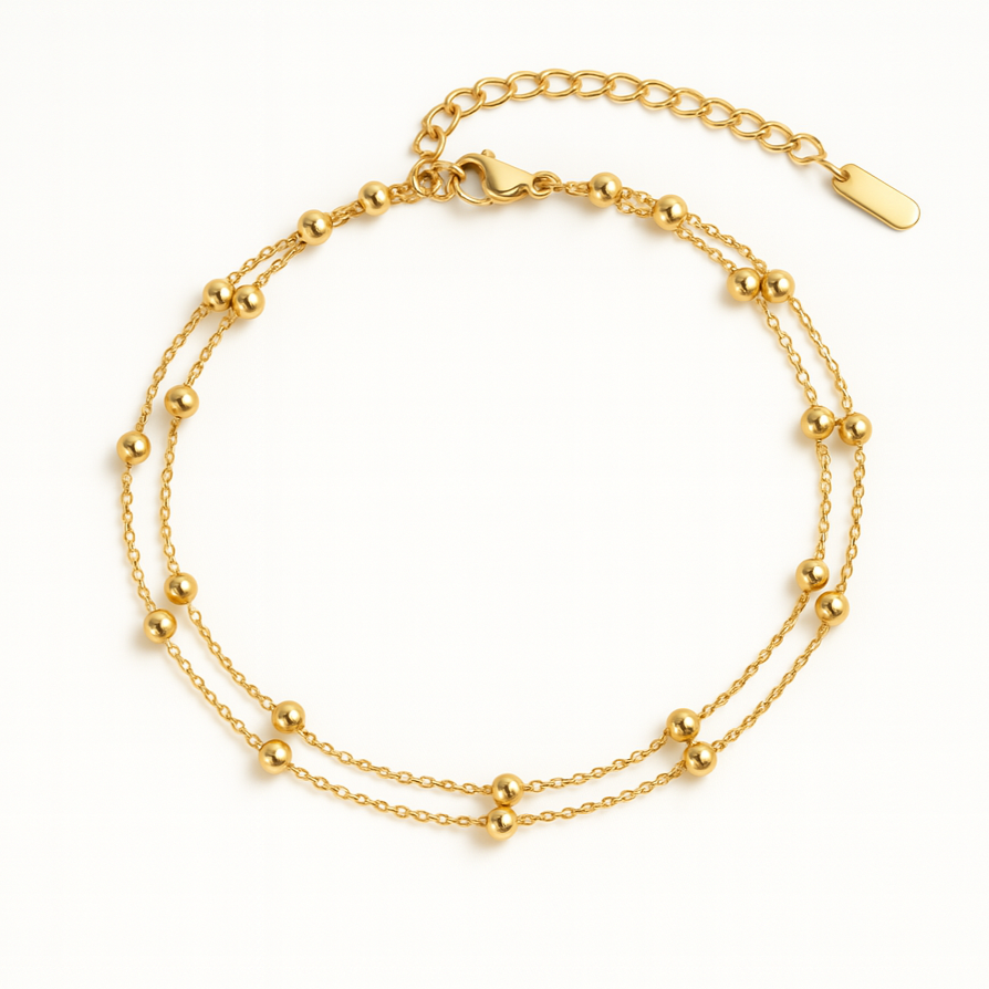 Gold bracelet with two layers on a white background